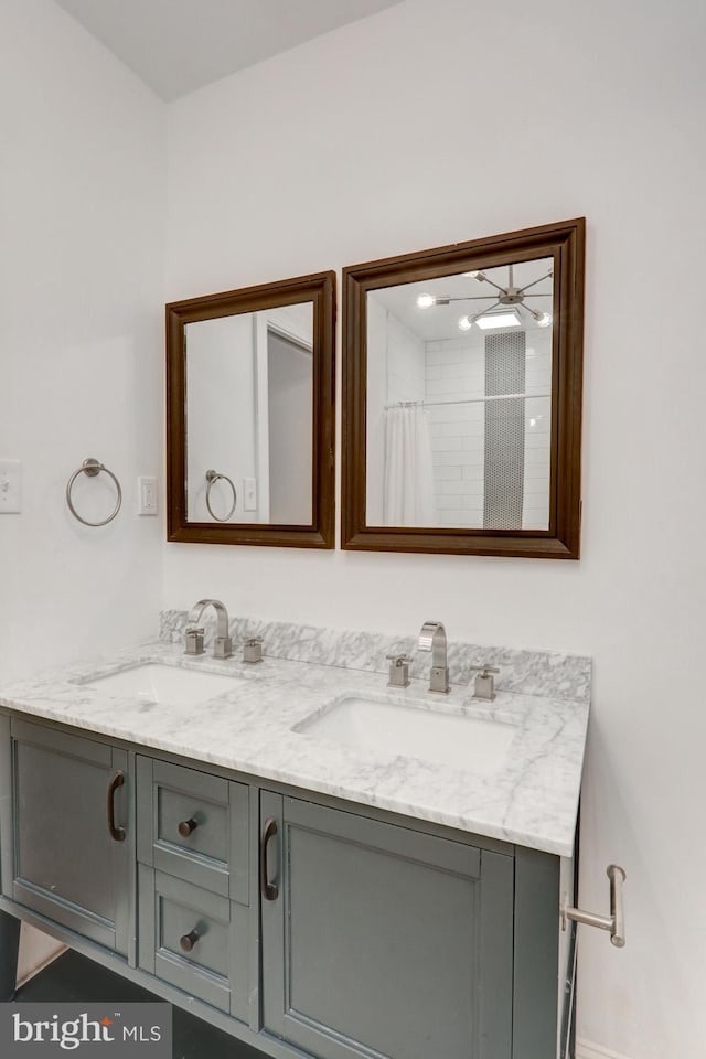 full bathroom featuring a sink and double vanity