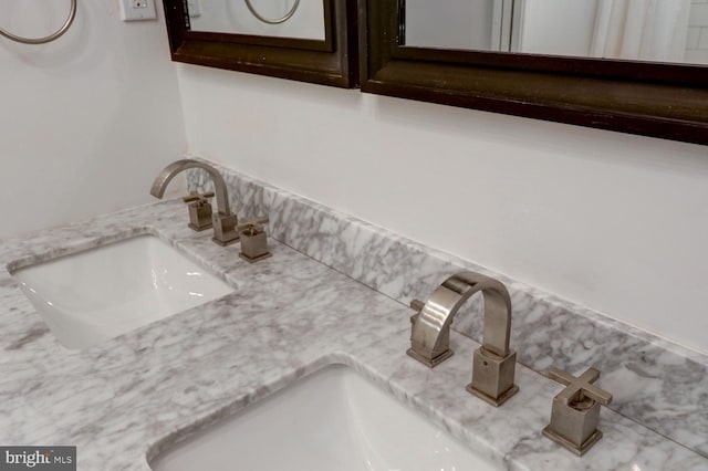 details featuring a sink and double vanity