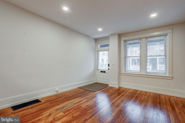 interior space with hardwood / wood-style flooring, baseboards, visible vents, and recessed lighting