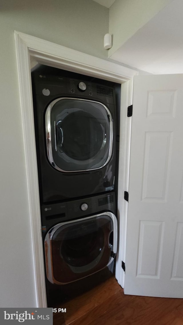 218 Stevenson Sq, Alexandria, VA 22304 - washroom with estacked washer and dryer and dark wood-style flooring