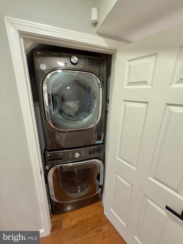 218 Stevenson Sq, Alexandria, VA 22304 - laundry area featuring stacked washer / dryer and wood finished floors