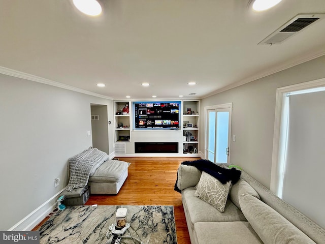 218 Stevenson Sq, Alexandria, VA 22304 - living area with ornamental molding, recessed lighting, wood finished floors, a fireplace, and built in shelves