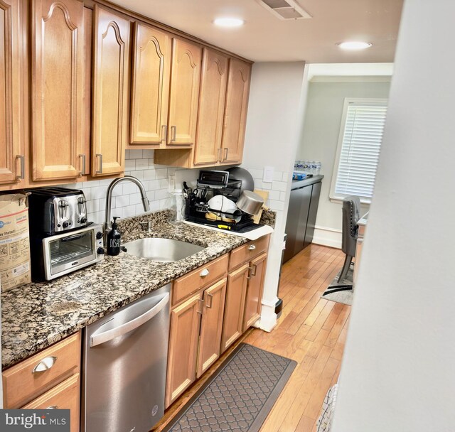 218 Stevenson Sq, Alexandria, VA 22304 - kitchen with stainless steel dishwasher, light wood-style flooring, tasteful backsplash, and light stone counters