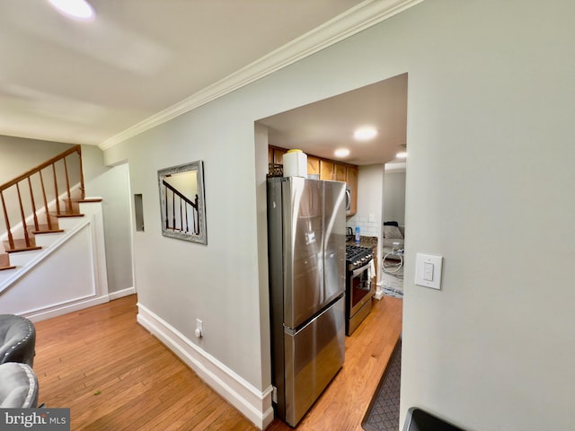 218 Stevenson Sq, Alexandria, VA 22304 - hallway with ornamental molding, stairway, light wood-style floors, and washer / dryer