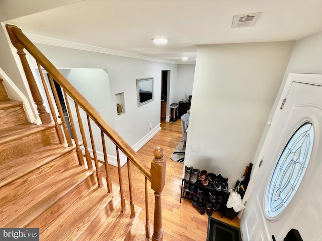 218 Stevenson Sq, Alexandria, VA 22304 - entryway with light wood-type flooring, stairs, and ornamental molding