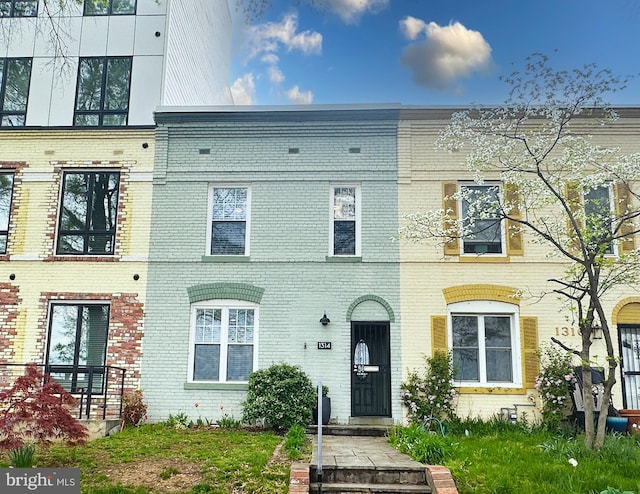townhome / multi-family property featuring brick siding