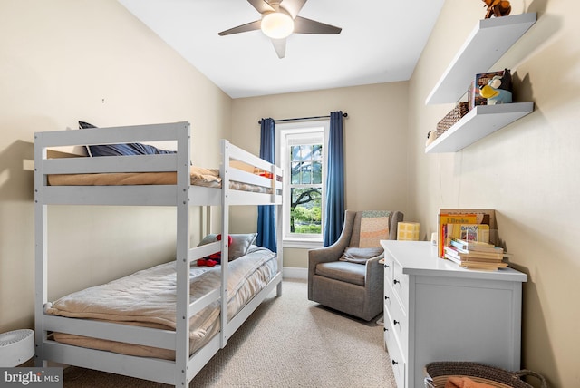 bedroom with ceiling fan, light colored carpet, and lofted ceiling