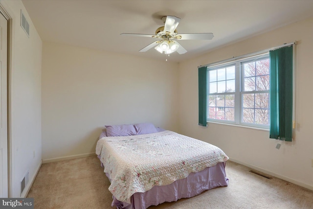 bedroom with light colored carpet, baseboards, and visible vents