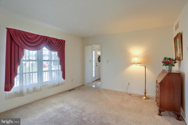 interior space with carpet floors, visible vents, and baseboards