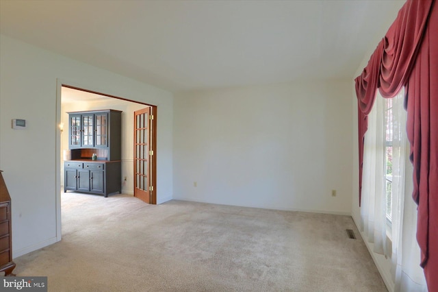 empty room with light carpet and visible vents