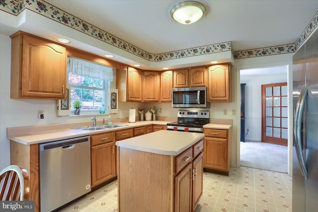 kitchen with light floors, light countertops, a sink, a center island, and appliances with stainless steel finishes