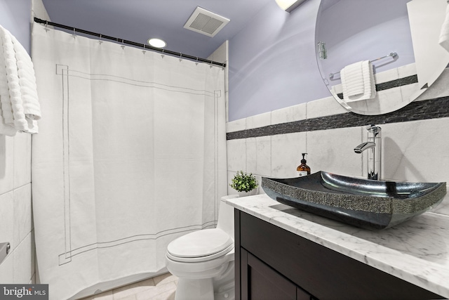 3440 Mansfield Rd, Falls Church, VA 22041 - bathroom featuring tile walls, toilet, and vanity