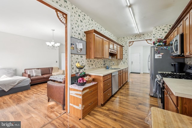 2 Underwood Ct, Burlington, NJ 08016 - kitchen with a sink, appliances with stainless steel finishes, light wood-style floors, wallpapered walls, and open floor plan