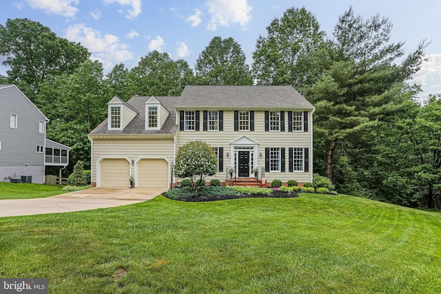 7098 Garden Walk, Columbia, MD 21044 - colonial home with concrete driveway, an attached garage, a front yard, and roof with shingles