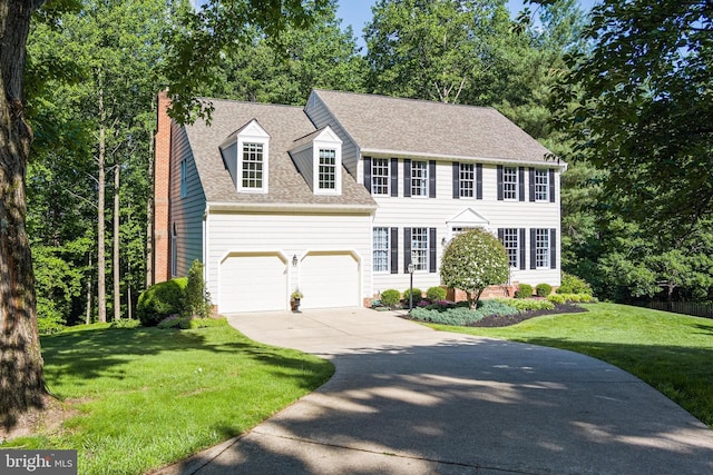 7098 Garden Walk, Columbia, MD 21044 - colonial-style house featuring driveway, a chimney, a front yard, roof with shingles, and an attached garage