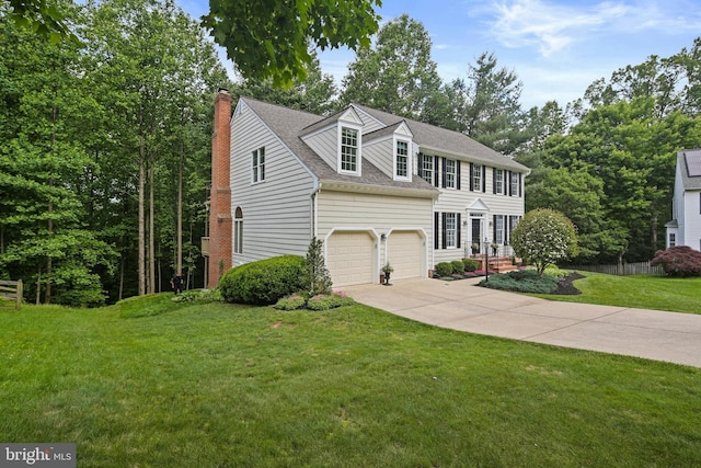 7098 Garden Walk, Columbia, MD 21044 - colonial-style house featuring concrete driveway, a front yard, a chimney, and a shingled roof
