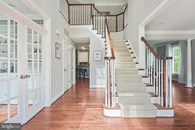 7098 Garden Walk, Columbia, MD 21044 - entrance foyer with french doors, stairs, wood finished floors, ornamental molding, and baseboards