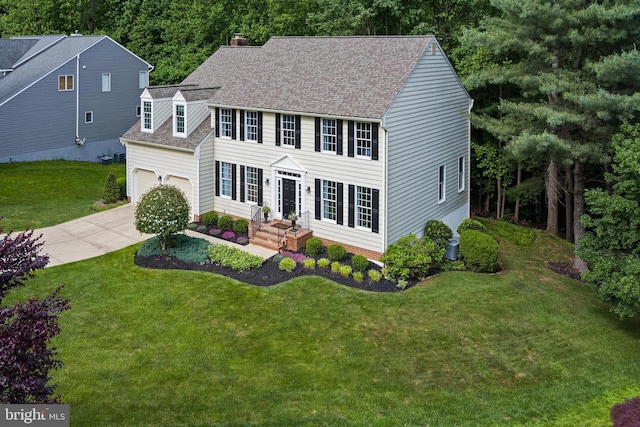 7098 Garden Walk, Columbia, MD 21044 - colonial house with a garage, driveway, roof with shingles, a front lawn, and a chimney