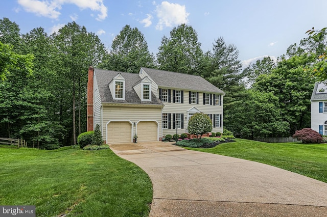 7098 Garden Walk, Columbia, MD 21044 - view of front of house featuring driveway, a front yard, a chimney, and a shingled roof