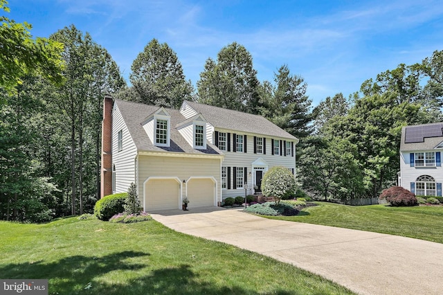 7098 Garden Walk, Columbia, MD 21044 - colonial house with driveway, a front lawn, a chimney, and an attached garage