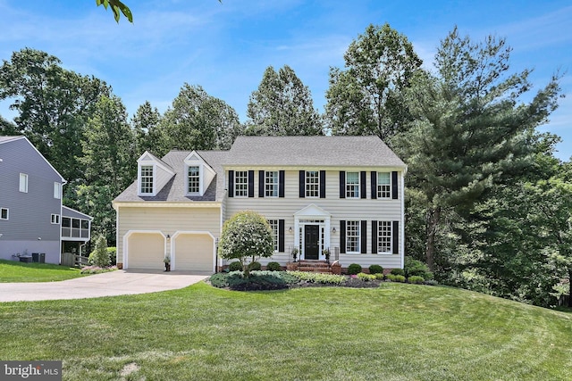 7098 Garden Walk, Columbia, MD 21044 - colonial-style house with driveway, a front yard, and an attached garage