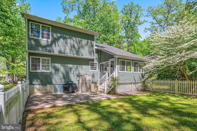 26 Capetown Rd, Ocean Pines, MD 21811 - back of house with crawl space, a sunroom, a patio area, a fenced backyard, and a yard
