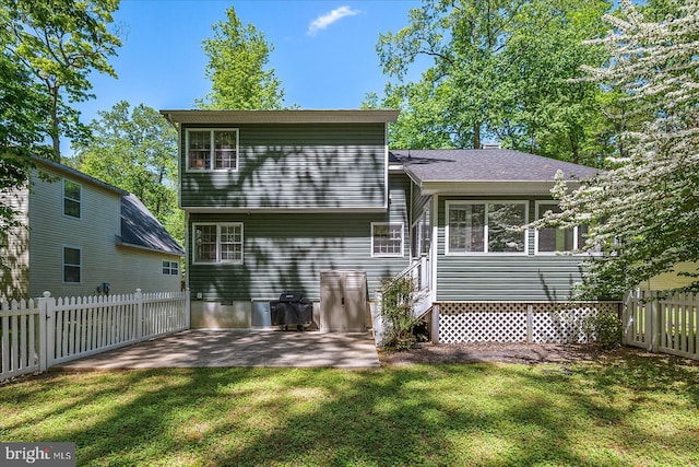 26 Capetown Rd, Ocean Pines, MD 21811 - rear view of property featuring a lawn, fence, and a patio