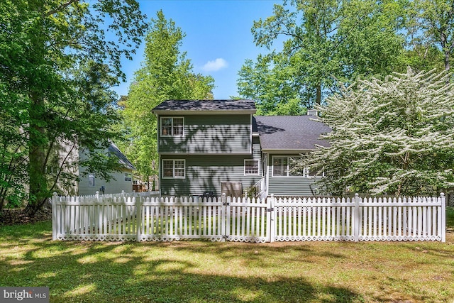 26 Capetown Rd, Ocean Pines, MD 21811 - back of property with a yard, fence, and a shingled roof