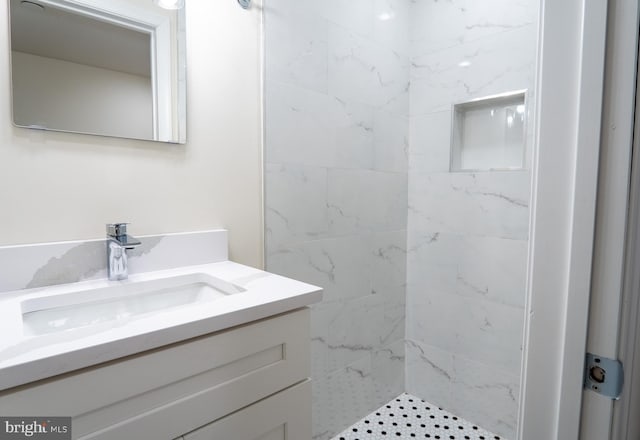 bathroom with a shower stall and vanity