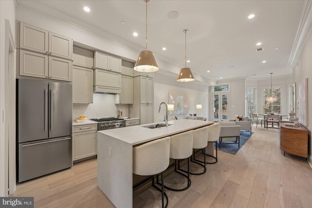 1335 11th St NW Unit 104, Washington, DC 20001 - kitchen featuring high end fridge, a sink, an island with sink, light countertops, and ornamental molding