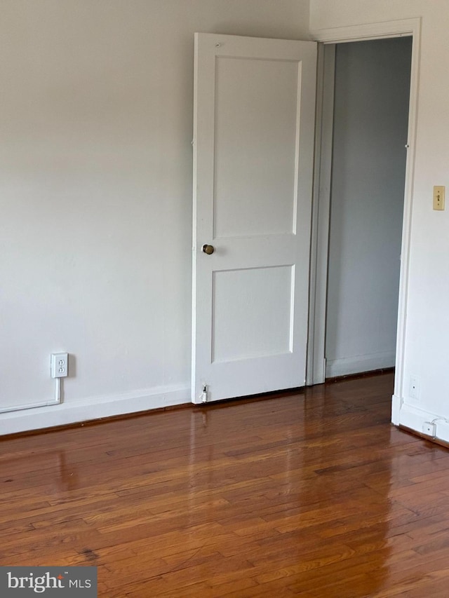 unfurnished bedroom featuring baseboards and wood finished floors