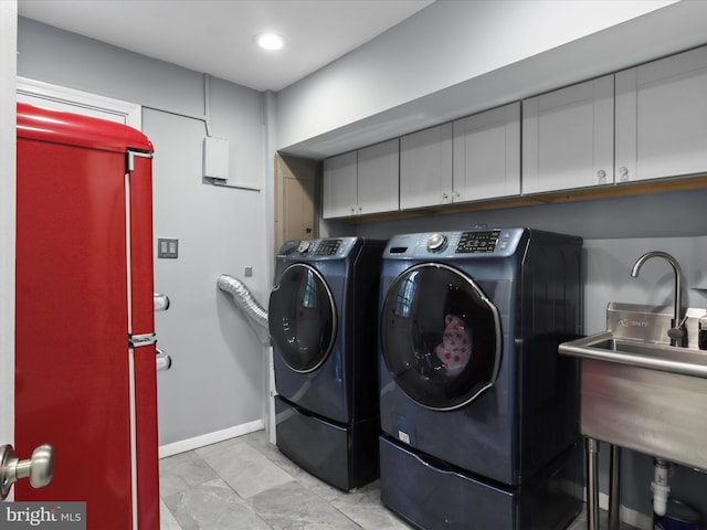 washroom featuring separate washer and dryer, baseboards, recessed lighting, and cabinet space