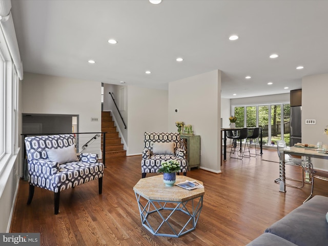 living room with stairs, recessed lighting, and wood finished floors