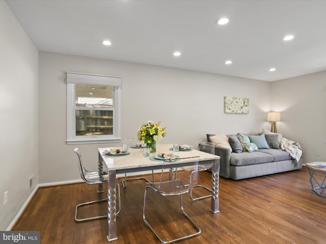 living room featuring baseboards, recessed lighting, and wood finished floors