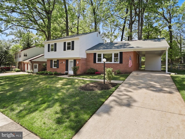 split level home with a carport, driveway, a front lawn, and brick siding