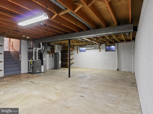 unfinished below grade area with heating unit, stairway, and electric water heater