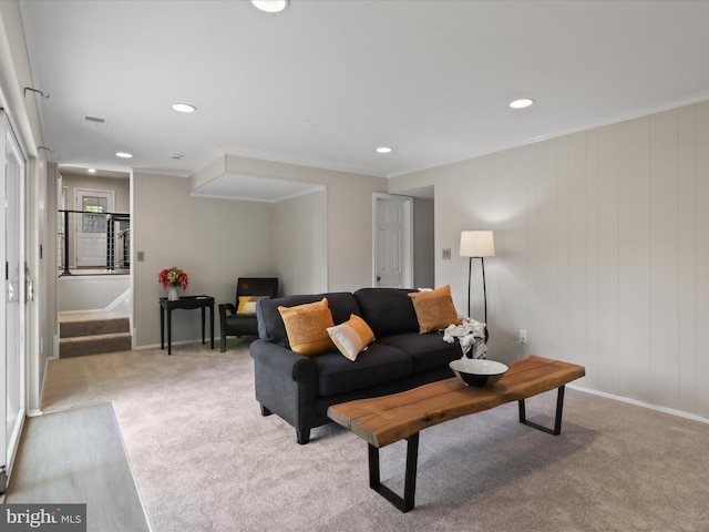 living area with recessed lighting, stairway, and carpet