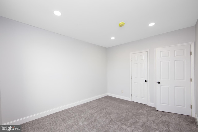 interior space featuring baseboards, recessed lighting, and carpet