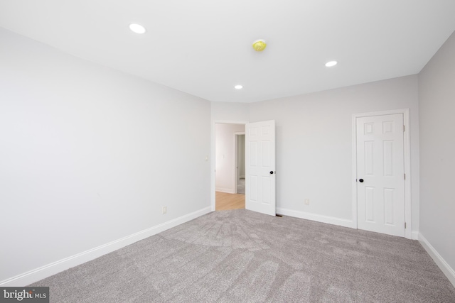 unfurnished room featuring baseboards, carpet floors, and recessed lighting