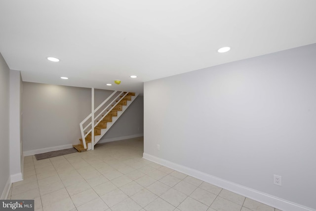 finished below grade area with recessed lighting, baseboards, and stairs