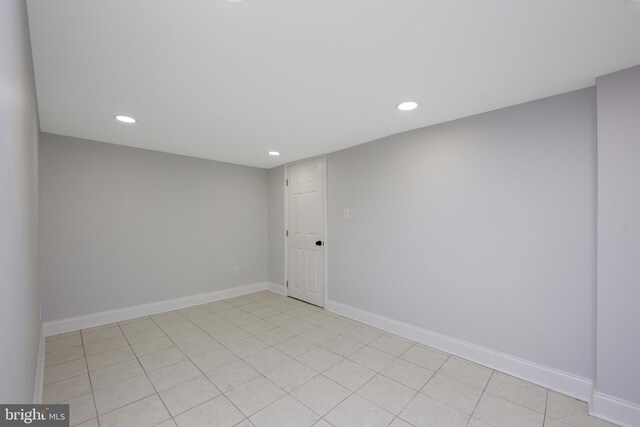 spare room featuring light tile patterned floors, baseboards, and recessed lighting