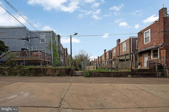 view of road with a residential view and street lighting