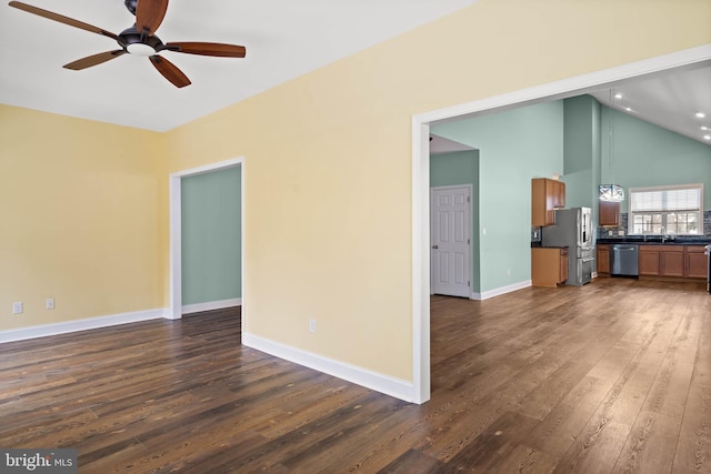 34795 Mute Swan Ln, Rehoboth Beach, DE 19971 - unfurnished living room featuring a sink, ceiling fan, baseboards, lofted ceiling, and dark wood-type flooring