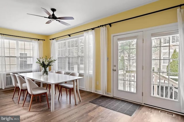 34795 Mute Swan Ln, Rehoboth Beach, DE 19971 - dining space with wood finished floors, visible vents, and a ceiling fan