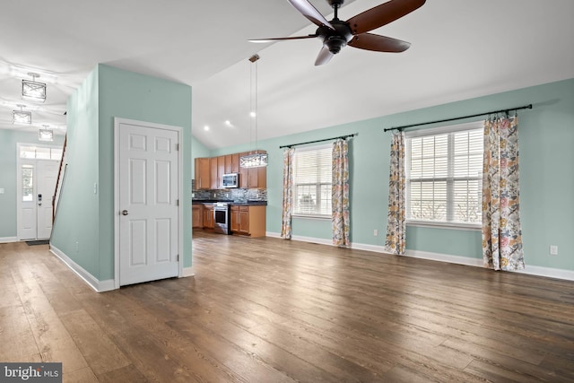 34795 Mute Swan Ln, Rehoboth Beach, DE 19971 - unfurnished living room featuring dark wood finished floors, ceiling fan, vaulted ceiling, and a wealth of natural light