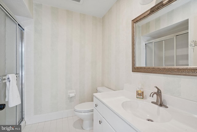 full bathroom featuring a shower stall, toilet, and vanity