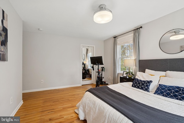 bedroom featuring light wood-style flooring and baseboards