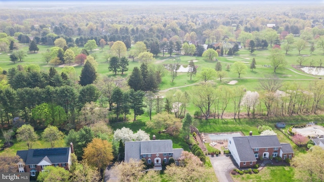 birds eye view of property with golf course view and a forest view