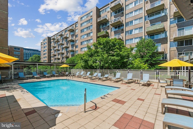 community pool featuring a patio and fence