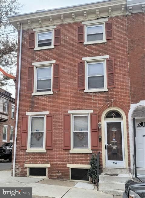 view of property with brick siding
